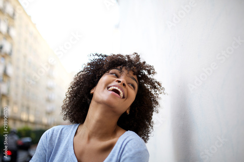 laughing young african american woman in city