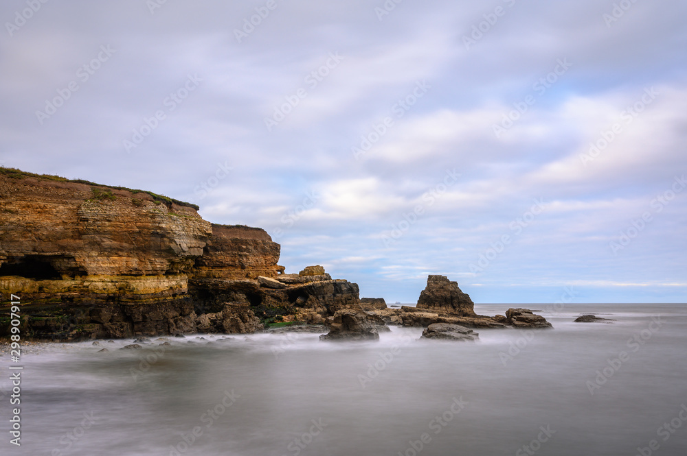 Long Exposure with cliffs and stacks, in a cove known as The Wherry, among Magnesian Limestone Cliffs just south of Souter Lighthouse which is full of caves and sea stacks