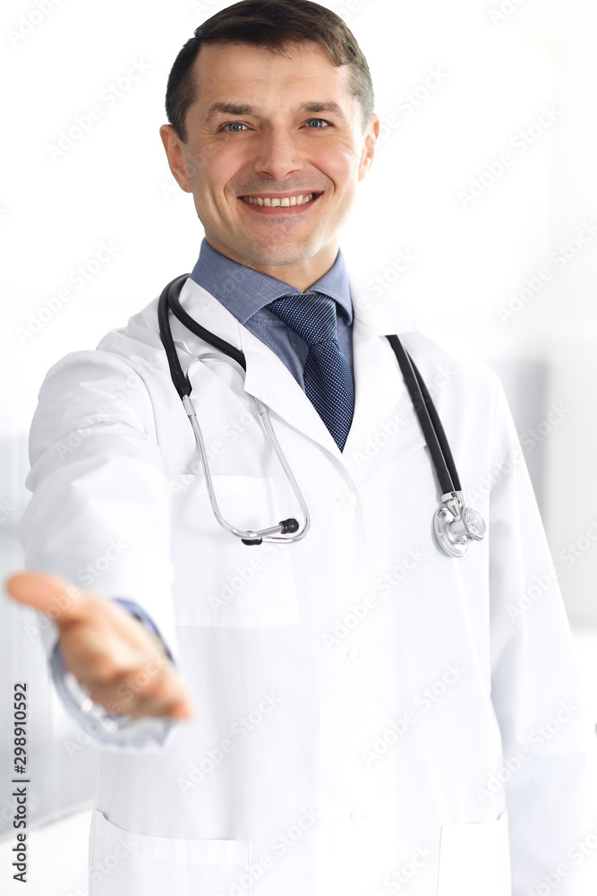 Doctor man cheerful smiling at camera, helping hand. Perfect medical service in clinic. Happy future in medicine and healthcare Doctor man cheerful smiling at camera, helping hand. Perfect medical service in clinic. Happy future in medicine and healthcare