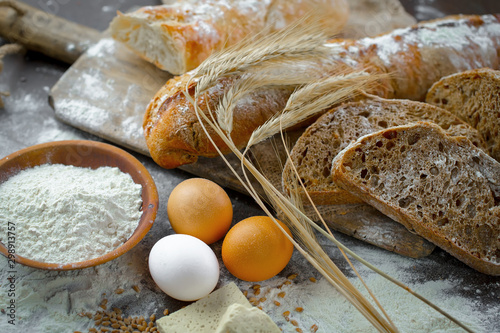 Bread in a composition with kitchen accessories on an old background