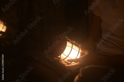 holding the lamp inside of the house in the first night