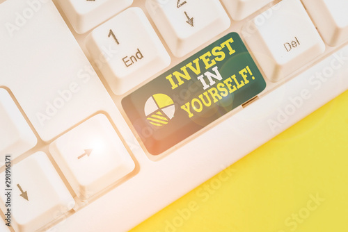 Writing note showing Invest In Yourself. Business concept for learn new things or materials thus making your lot better White pc keyboard with note paper above the white background photo