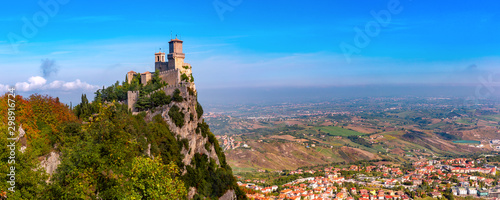 Panorama of First tower Guaita fortress in the city of San Marino of the Republic of San Marino and italian hills in sunny day photo