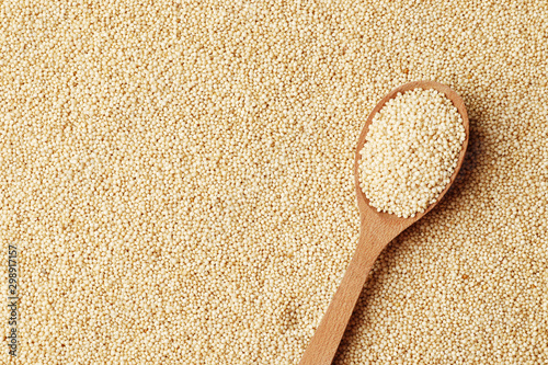 Amaranth in a wooden spoon on the background of porridge