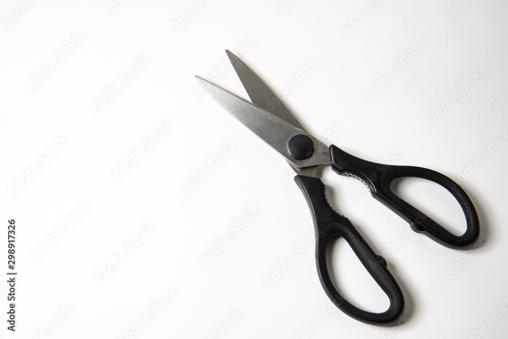 Metal scissors with black handles on a white background Metal scissors with black handles on a white background