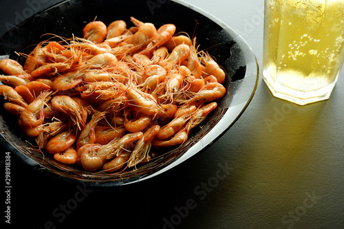 Shrimp with beer on a black background photo