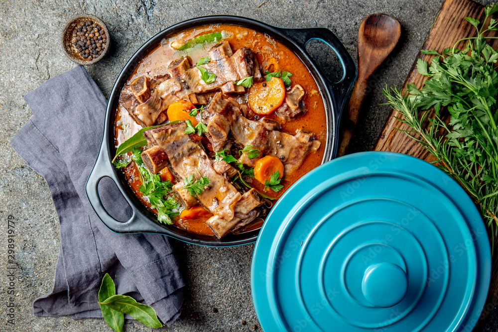 Beef ribs Bourguignon. Beef ribs stewed with carrot, onion in red wine. France dish Beef ribs Bourguignon. Beef ribs stewed with carrot, onion in red wine. France dish