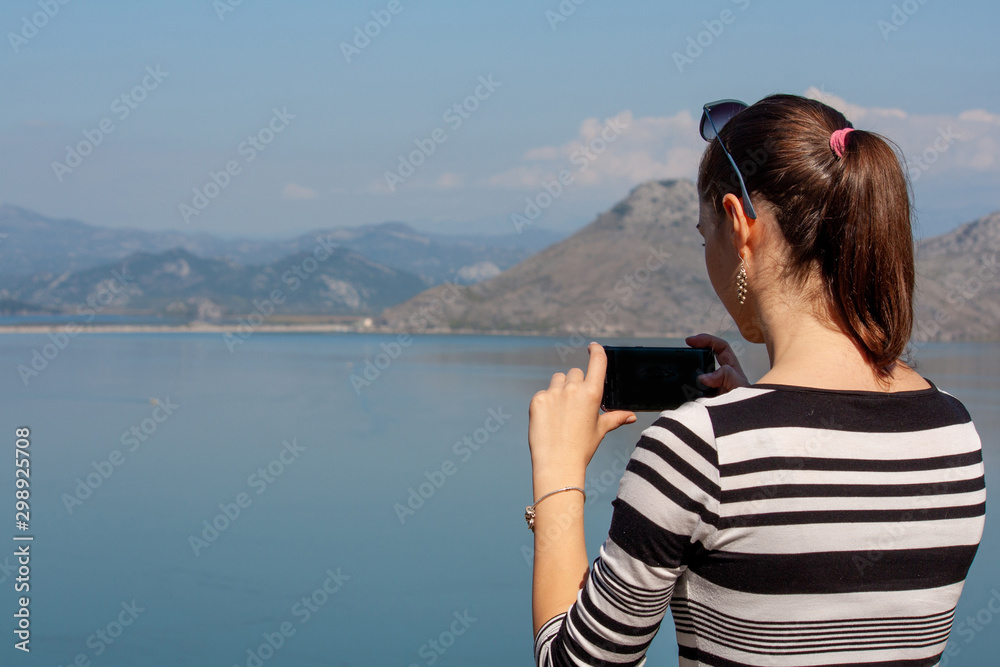 young woman taking photo with smartphone