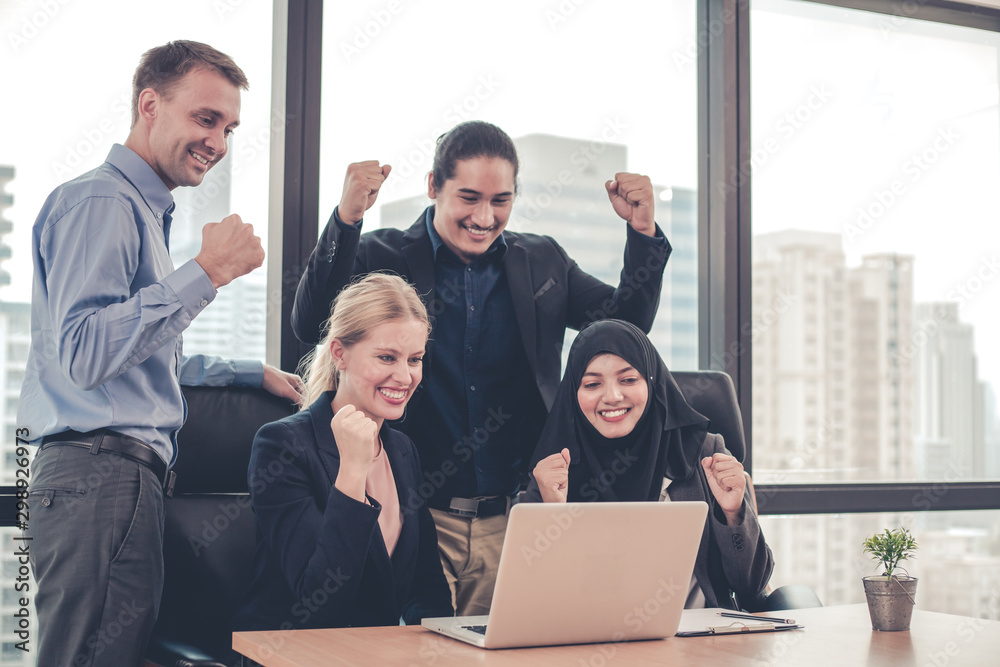 Group of office workers are successful working together with a smile on their laptop. Group of office workers are successful working together with a smile on their laptop.
