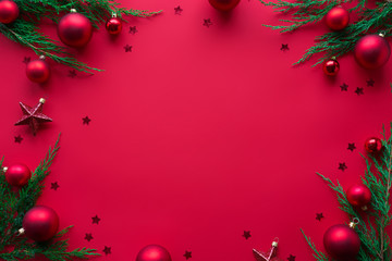 Merry Christmas red background decorated with happy 2020 new year tree branches and baubles stars, winter holiday card decorations festive merry xmas concept, flat lay, above top view, copy space