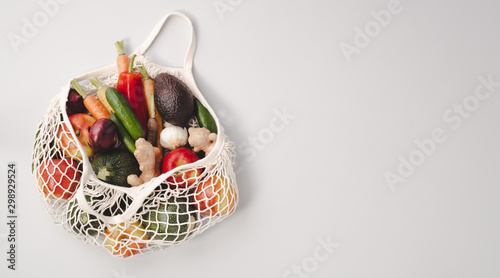 Fototapeta Naklejka Na Ścianę i Meble -  Fresh organic fruits and vegetables in mesh textile bag