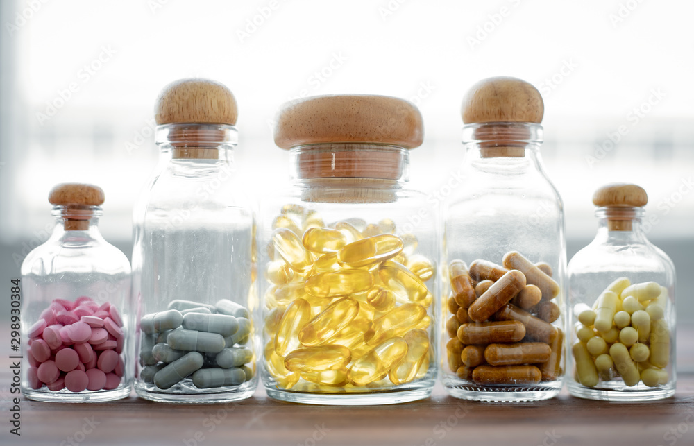 Medicine in glass bottle on wood background. Medicine in glass bottle on wood background.