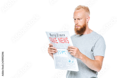 handsome serious man reading newspaper with fake news, isolated on white