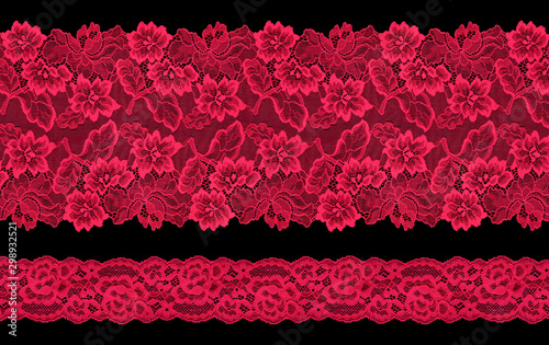 Set of red lace ribbons on a black background. Lace braid.