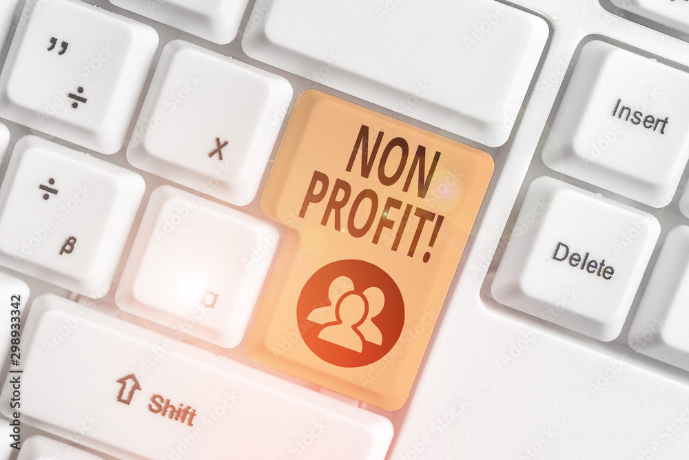 Conceptual hand writing showing Non Profit. Concept meaning not making or conducted primarily to make profit organization White pc keyboard with note paper above the white background Conceptual hand writing showing Non Profit. Concept meaning not making or conducted primarily to make profit organization White pc keyboard with note paper above the white background