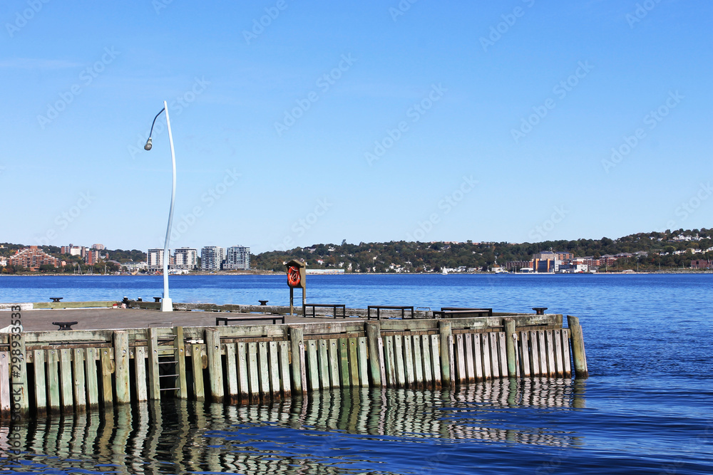 Looking out over Halifax Harbour, Halifax, Nova Scotia, Canada. Partial view of dock in foreground. Looking out over Halifax Harbour, Halifax, Nova Scotia, Canada. Partial view of dock in foreground.