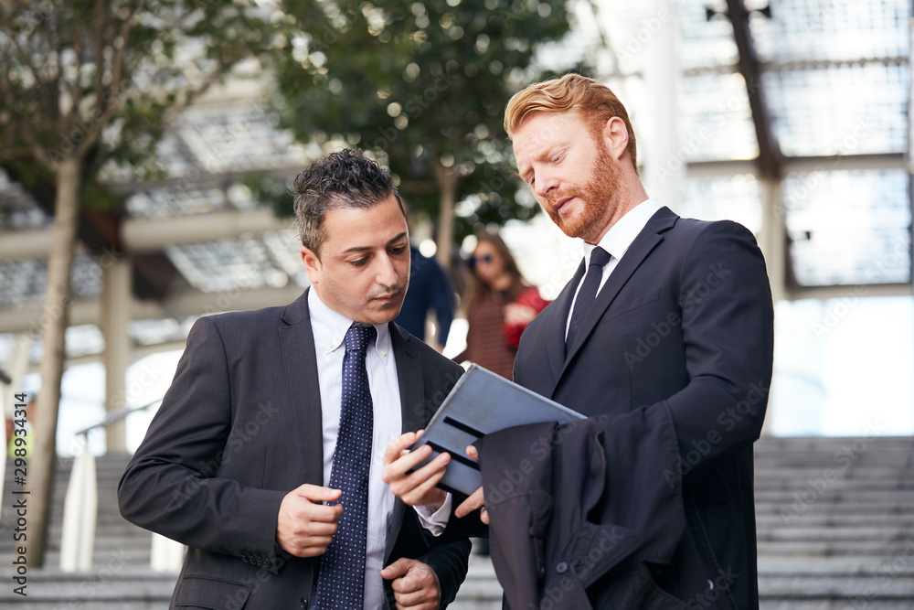 business people working outside office building business people working outside office building