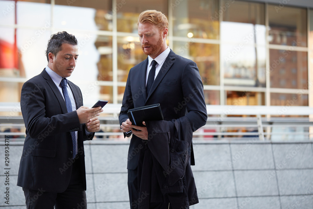 Fototapeta premium business people working outside office building