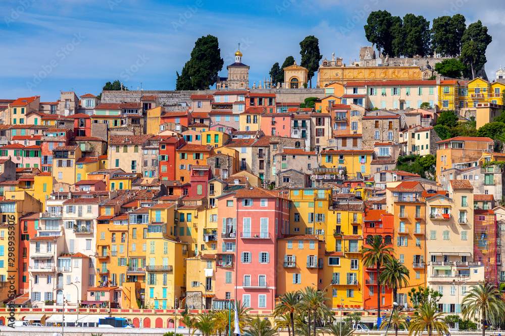 Menton. Antique multi-colored facades of medieval houses on the shore of the bay.
