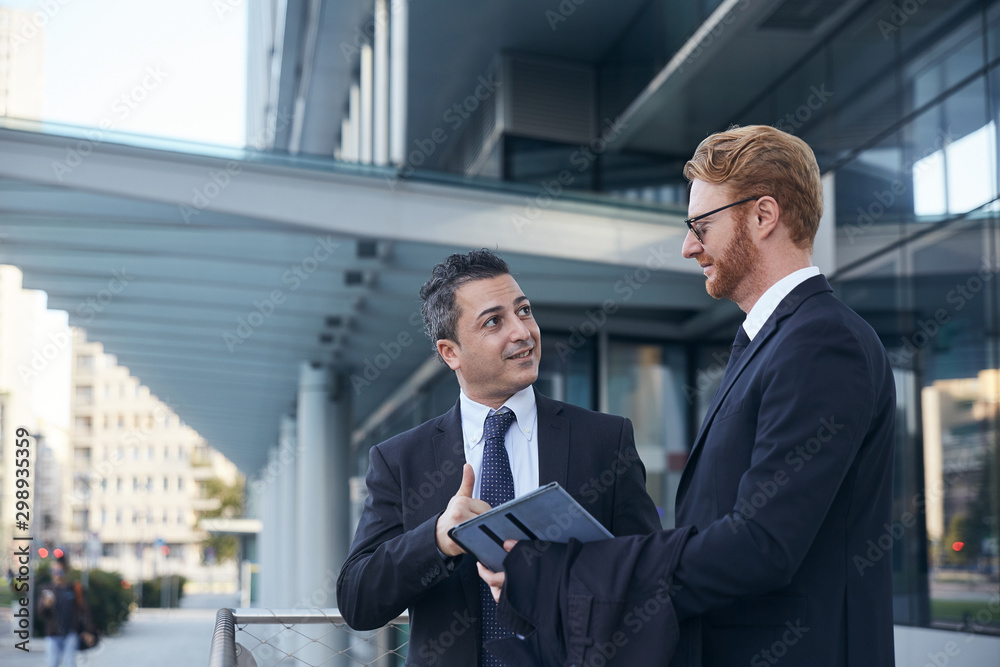 business people working outside office building