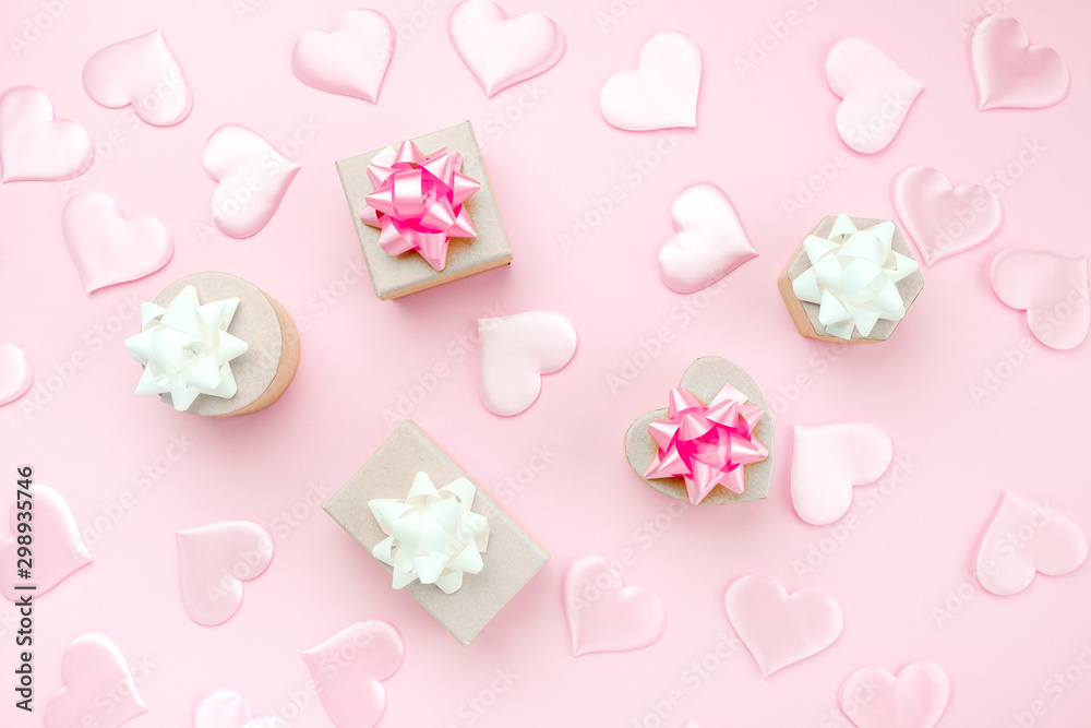Beautiful silk hearts, gift box , white and pink holiday bows on a pink background, pastel colors . Celebrate concept. Flat lay . Beautiful silk hearts, gift box , white and pink holiday bows on a pink background, pastel colors . Celebrate concept. Flat lay .