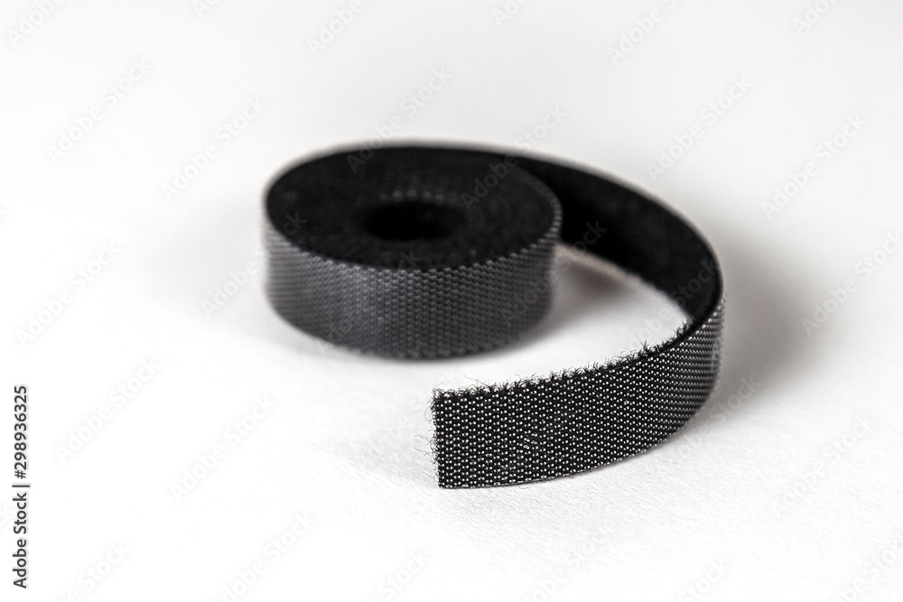 Velcro tape in a roll closeup on a white background Velcro tape in a roll closeup on a white background