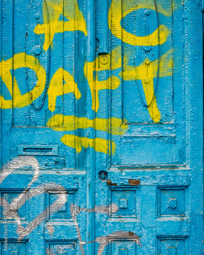 Old Blue Grunge Door with vandal inscriptions