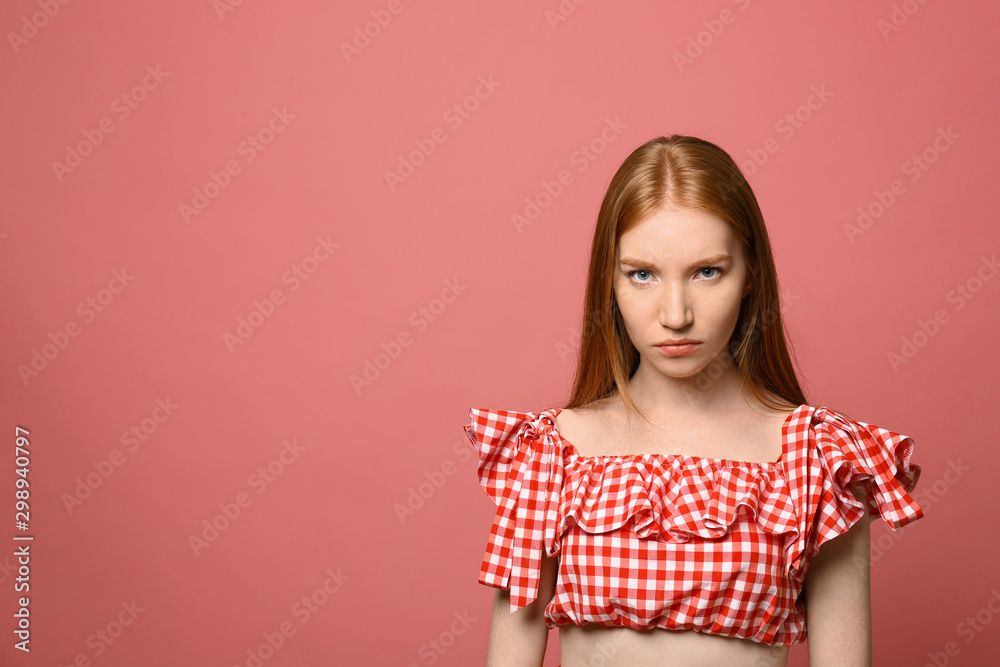 Portrait of angry young woman on pink background Portrait of angry young woman on pink background