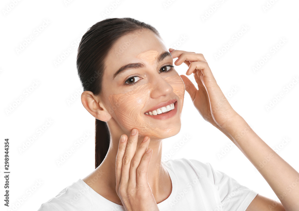 Happy young woman with organic mask on her face against white background Happy young woman with organic mask on her face against white background