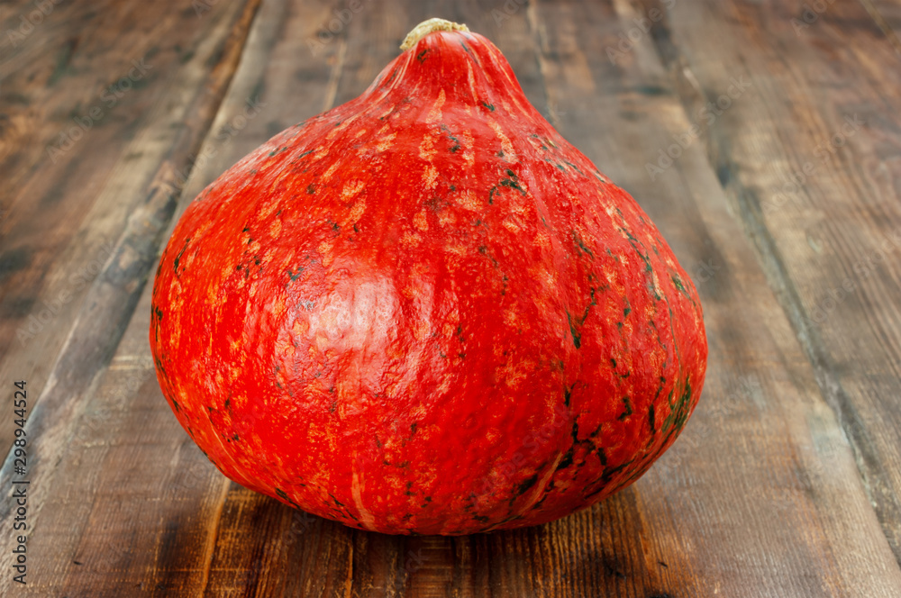 Hokkaido pumpkin on wooden table.