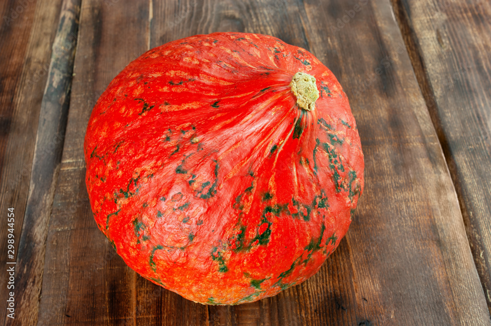 Hokkaido pumpkin on wooden table.