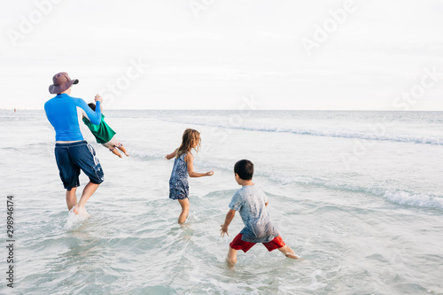 Father with Children Playing in the Ocean