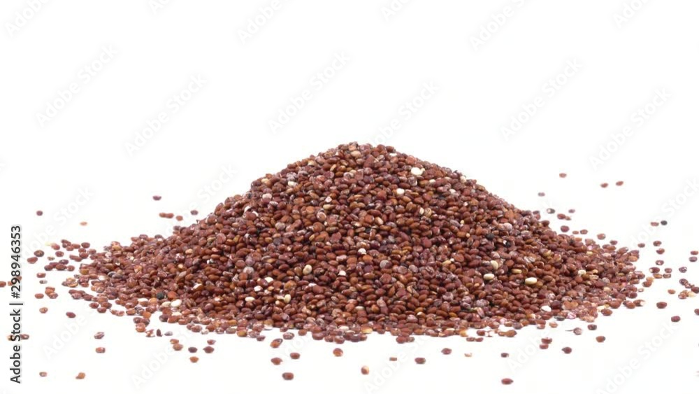 Close-up of uncooked red quinoa seeds rotating. Nutritious food concept. Isolated, on white background. Copy space shot Close-up of uncooked red quinoa seeds rotating. Nutritious food concept. Isolated, on white background. Copy space shot