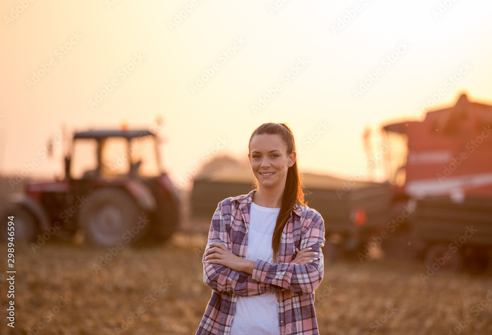 Farmer woman with crossed arms at corn harvest - obrazy, fototapety, plakaty 