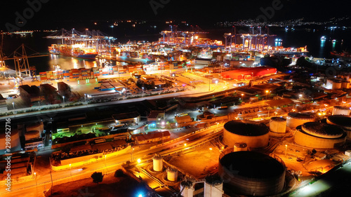 Aerial night shot of illuminated industrial cargo truck size container terminal in Perama and Drapetsona commercial port near Piraeus  Attica  Greece