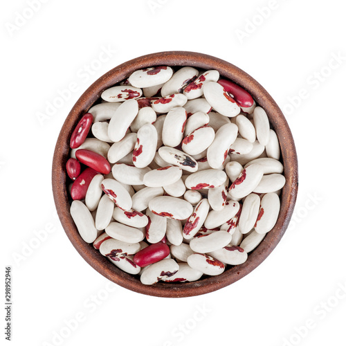 raw white beans with red in a ceramic cup, top view, isolated close-up