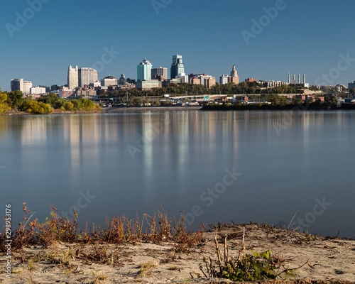 Downtown Kansas City skyline reflecting in water where Missouri River and Kansas River meet photo