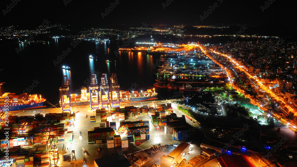 Obraz premium Aerial night shot of illuminated industrial cargo truck size container terminal in Asia port