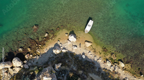 Aerial top down view of tropical exotic rocky bay with emerald sea