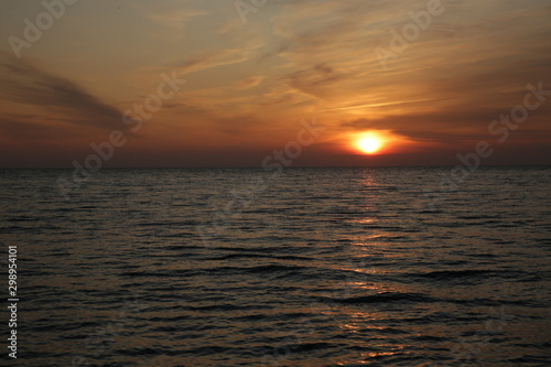 sunset over the sea with reflection in the water.