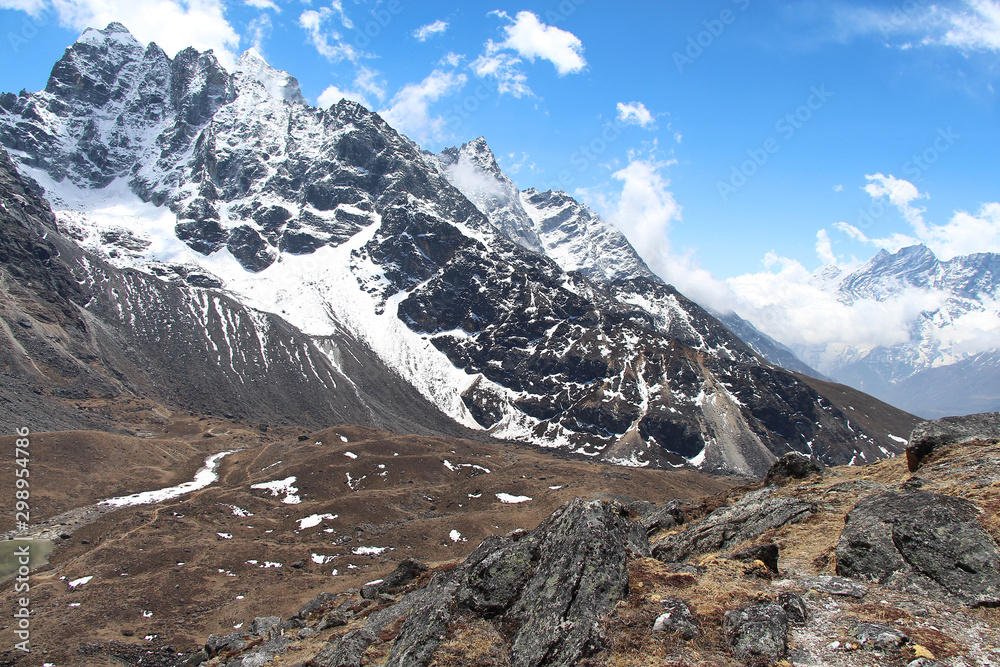 View of Kyajo Ri mountain peak (6151 meters) in Himalayas in Nepal near Lunden village and Renjo Pass. White clouds begin to gather over the mountain valley.