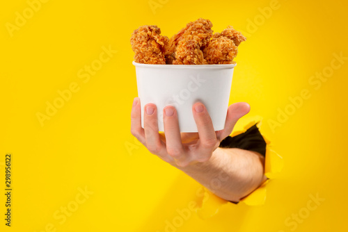 Hand giving chicken nuggets