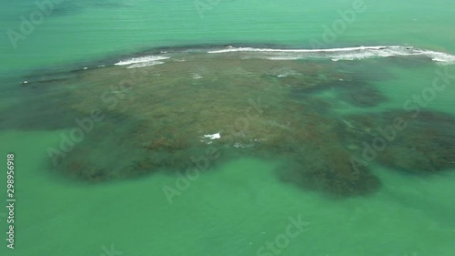 Aerial view over coral reefs widespread on turquoise lagoon near Paripueira Beach in Brazil photo