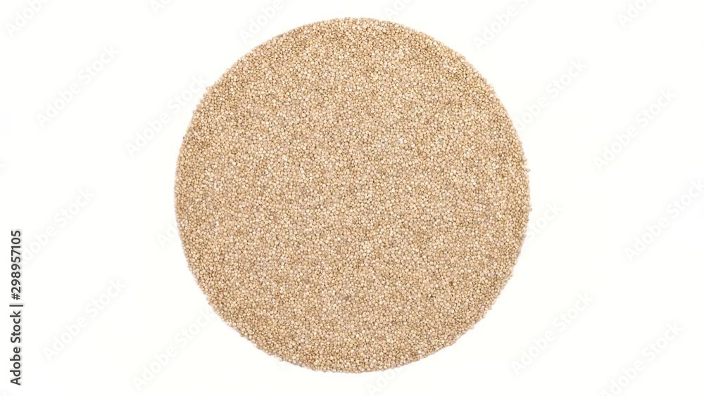 Close-up of white quinoa seeds rotating. Cereal texture demonstration. Gluten free food concept. Close-up of white quinoa seeds rotating. Cereal texture demonstration. Gluten free food concept.