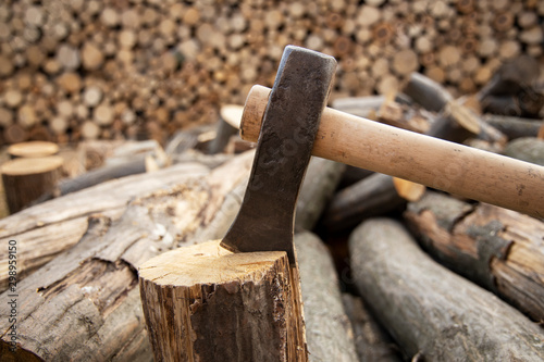 Ax stuck in the stump. wooden stump in the forest. Deforestation man. Felled tree. Woodcutter's ax on the stump.