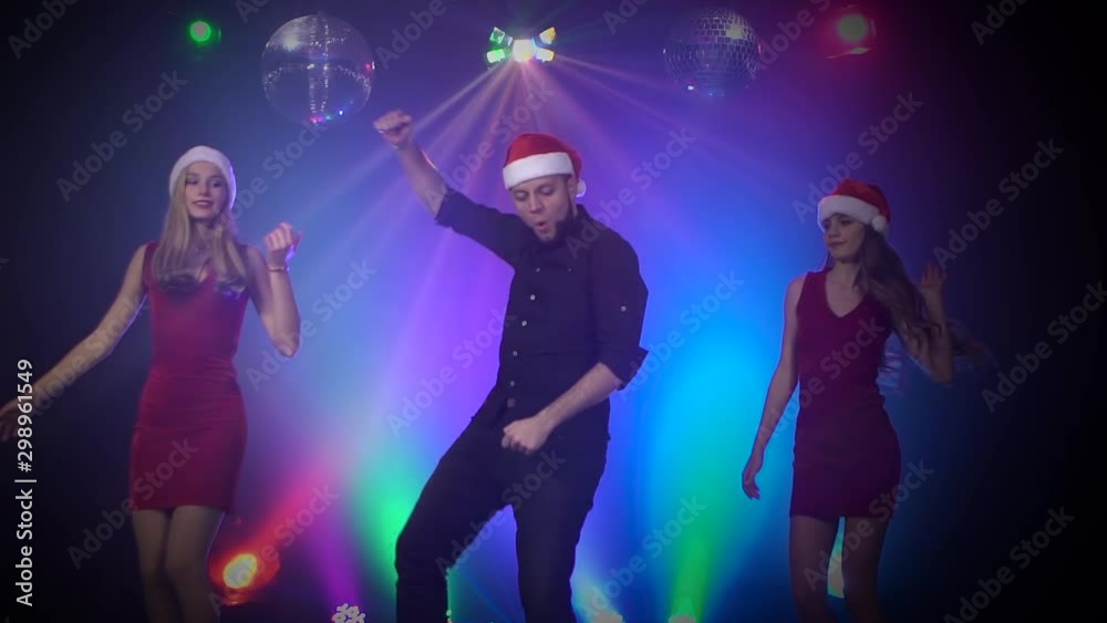 New year party people concept having fun dancing at a party. Smoky colorful background. Slow motion