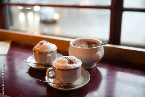 two cups of coffee at a cafe near the window