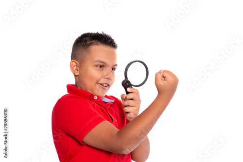 Shot of a  boy  examining  through a magnifying glass  his cam