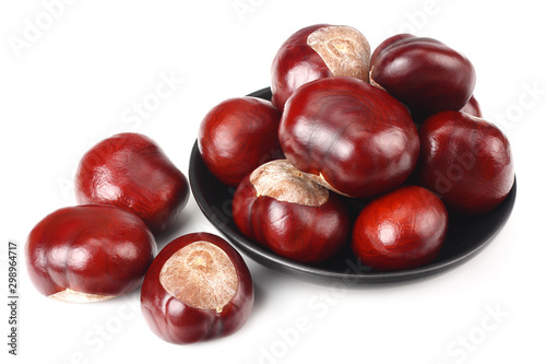 chestnuts in a black plate isolated on white background