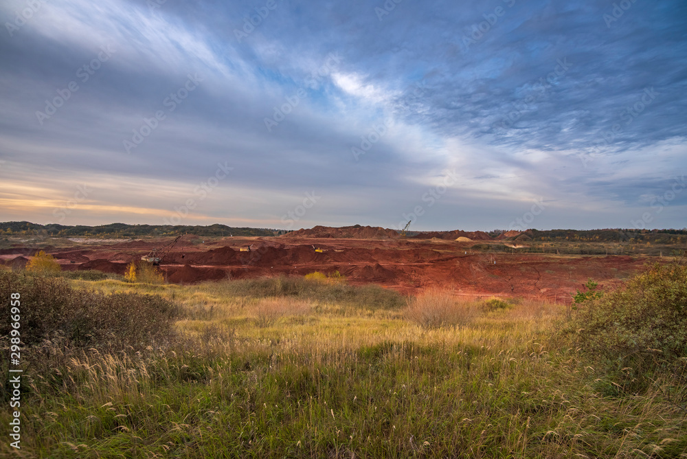 Red clay quarry - Blue sky during an autumn sunrise